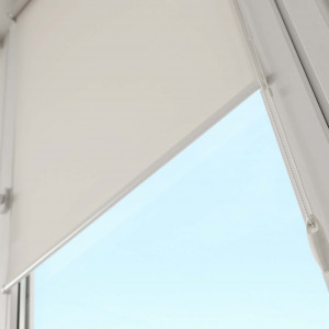 Window with modern roll blinds in room, closeup